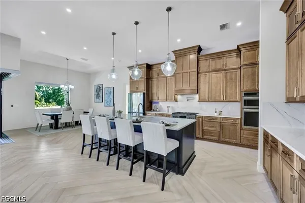 a large kitchen with a table and chairs