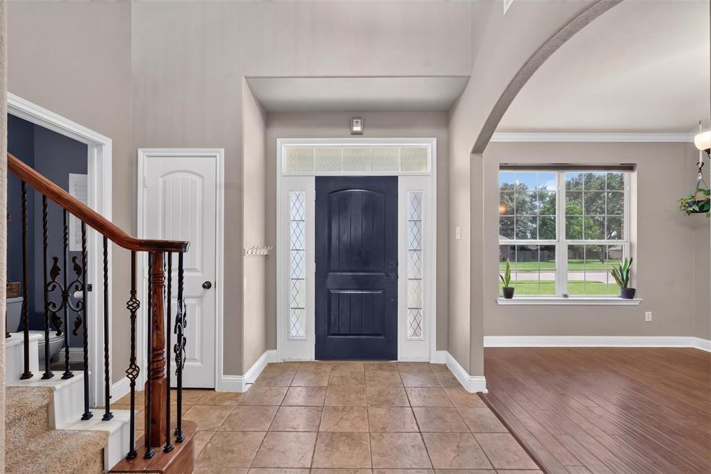 517 Austin Acre Road Sulphur Springs, TX 75482 - Photo 5 of 23 a view of an empty room with wooden floor and a window