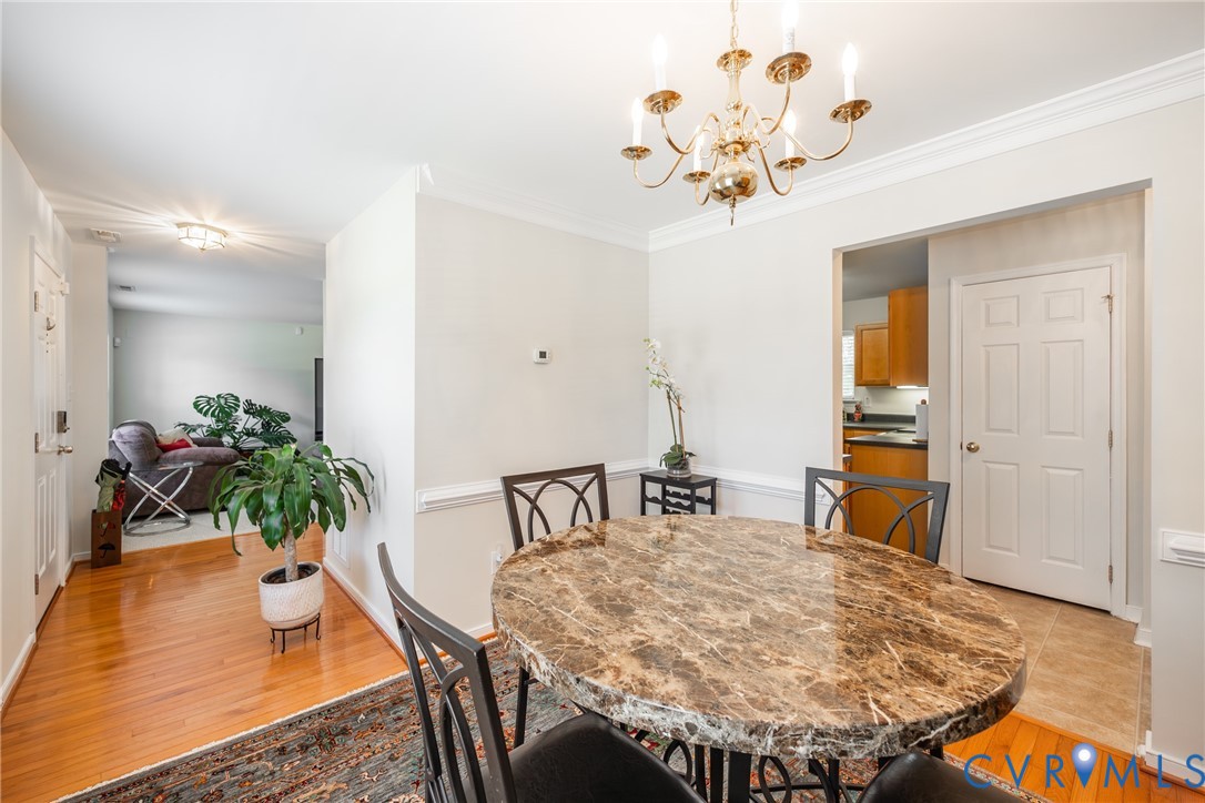 2928 Heather Ridge Drive Henrico, VA 23231 - Photo 6 of 34 Dining area featuring a brass chandelier, crown mo