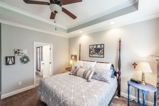 a bedroom with a large bed and a chandelier