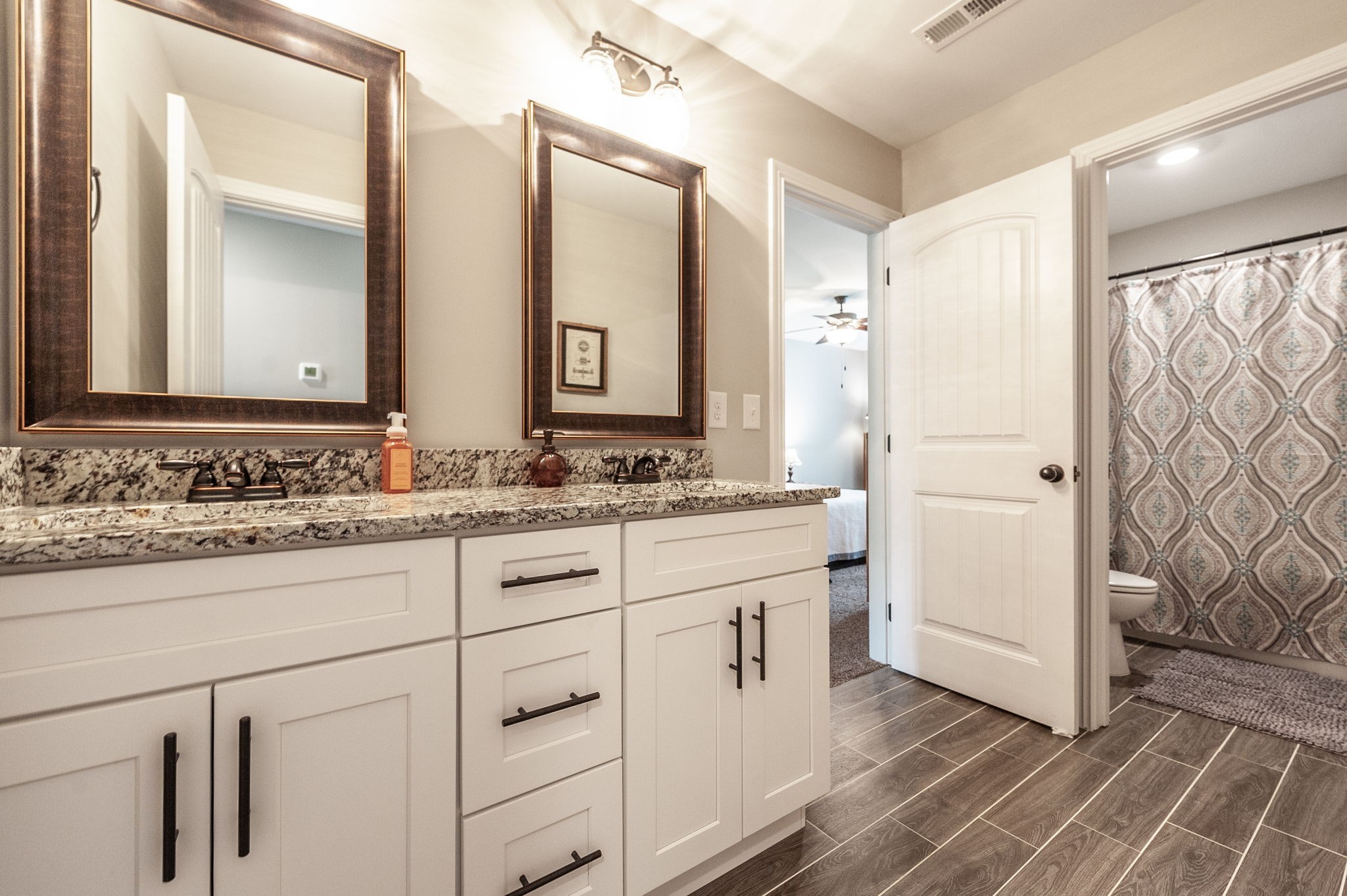 1184 Wicke Road Adams, TN 37010 - Photo 17 of 41 a bathroom with a granite countertop sink and a mirror