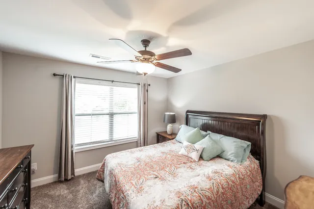 a bedroom with a large bed and a window