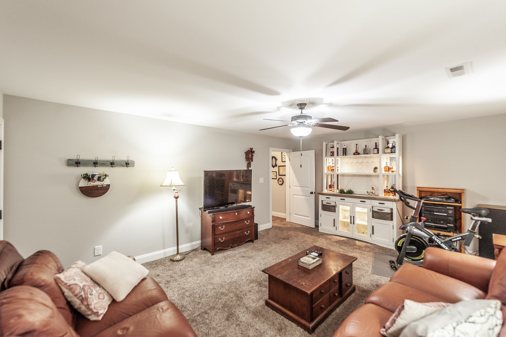 1184 Wicke Road Adams, TN 37010 - Photo 33 of 41 a living room with furniture a flat screen tv and kitchen view