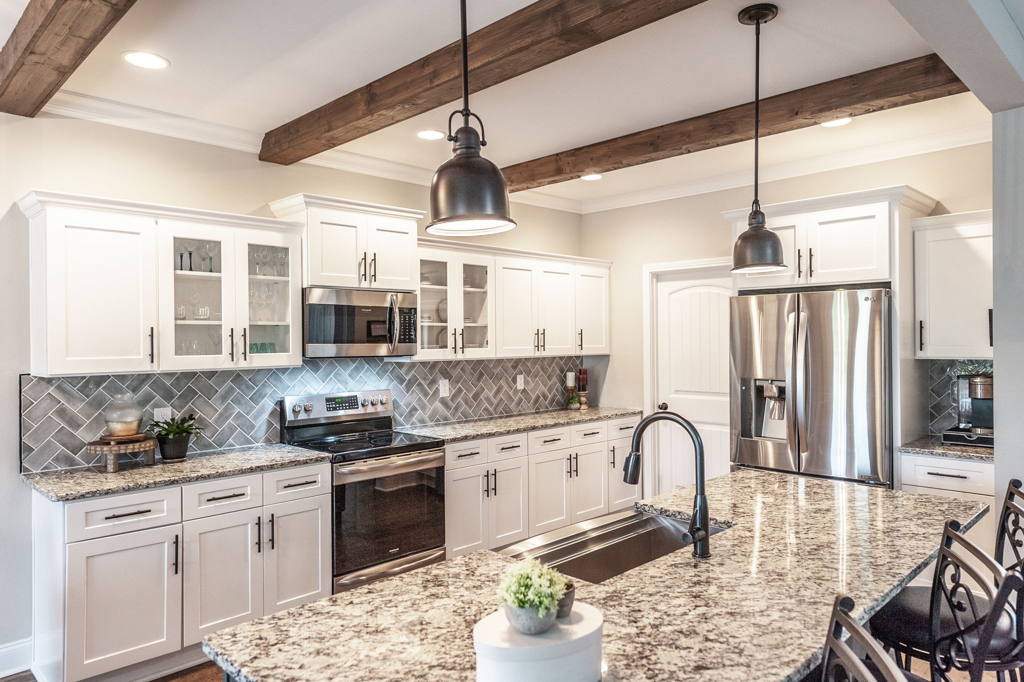 1184 Wicke Road Adams, TN 37010 - Photo 8 of 41 a kitchen with stainless steel appliances granite countertop a stove a sink dishwasher a refrigerator with white cabinets and wooden floor