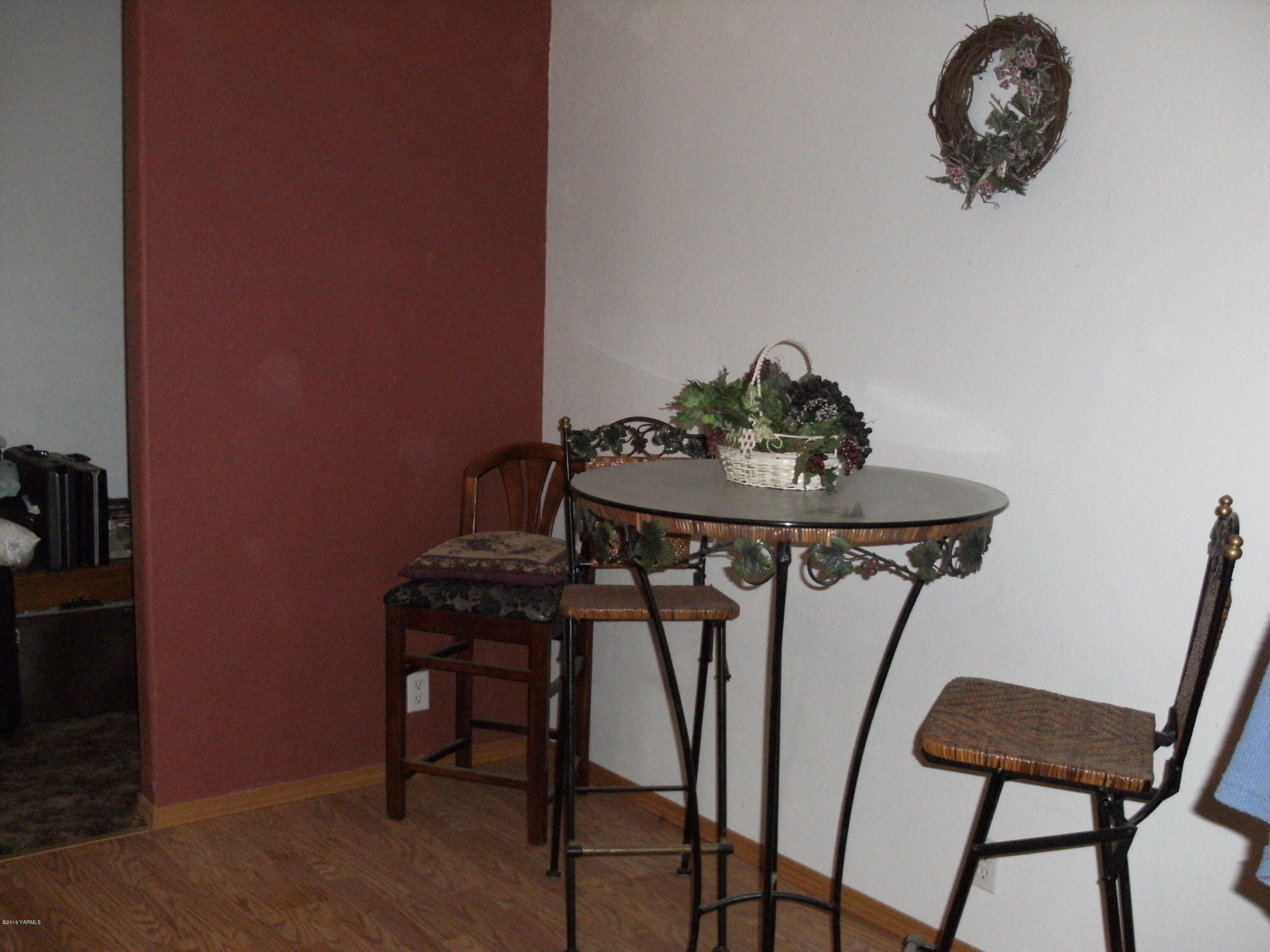 1009 Thornton Road Sunnyside, WA 98944 - Photo 12 of 18 a view of a workspace with furniture and wooden floor