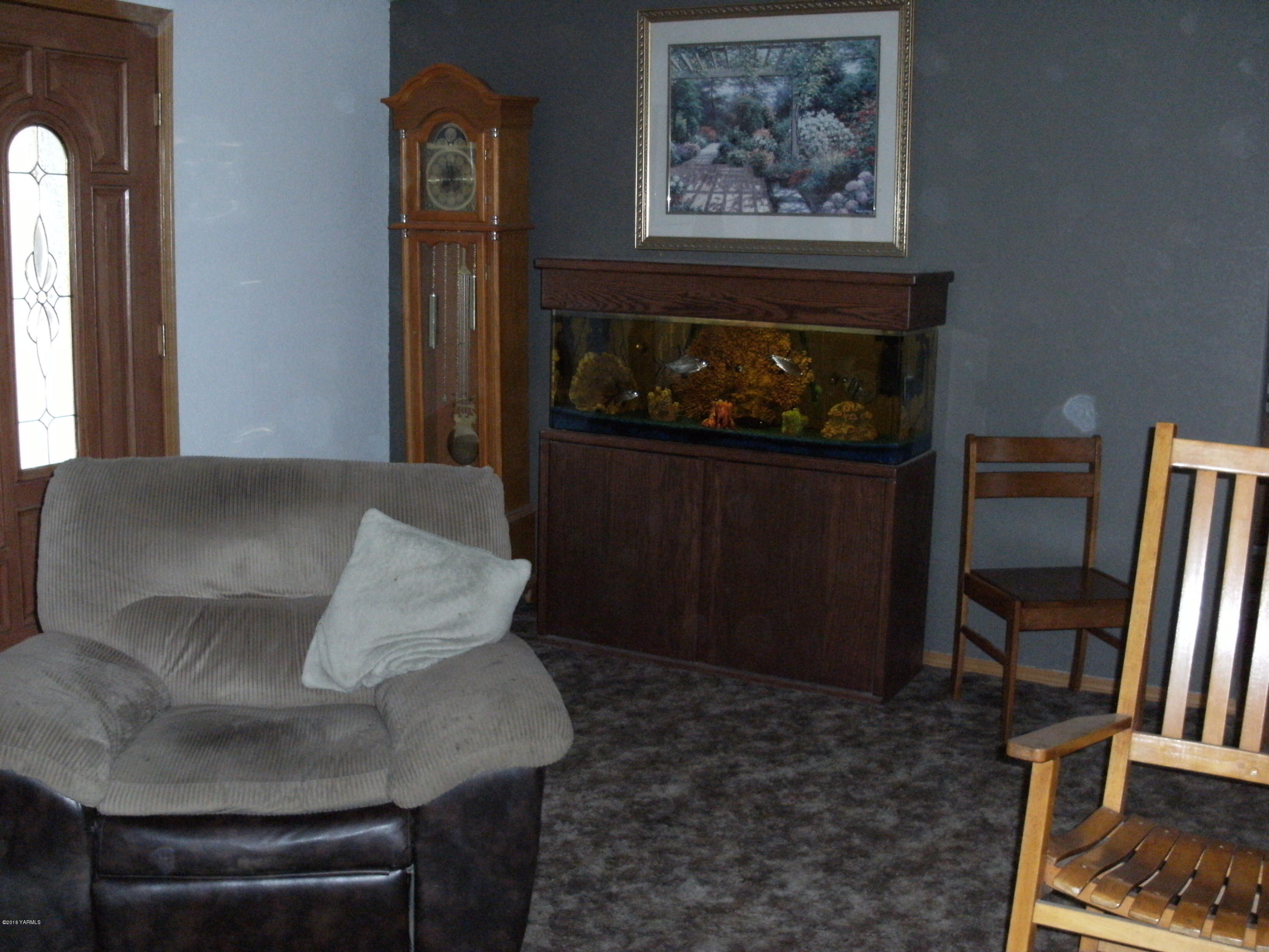 1009 Thornton Road Sunnyside, WA 98944 - Photo 14 of 18 a living room with furniture and a fireplace
