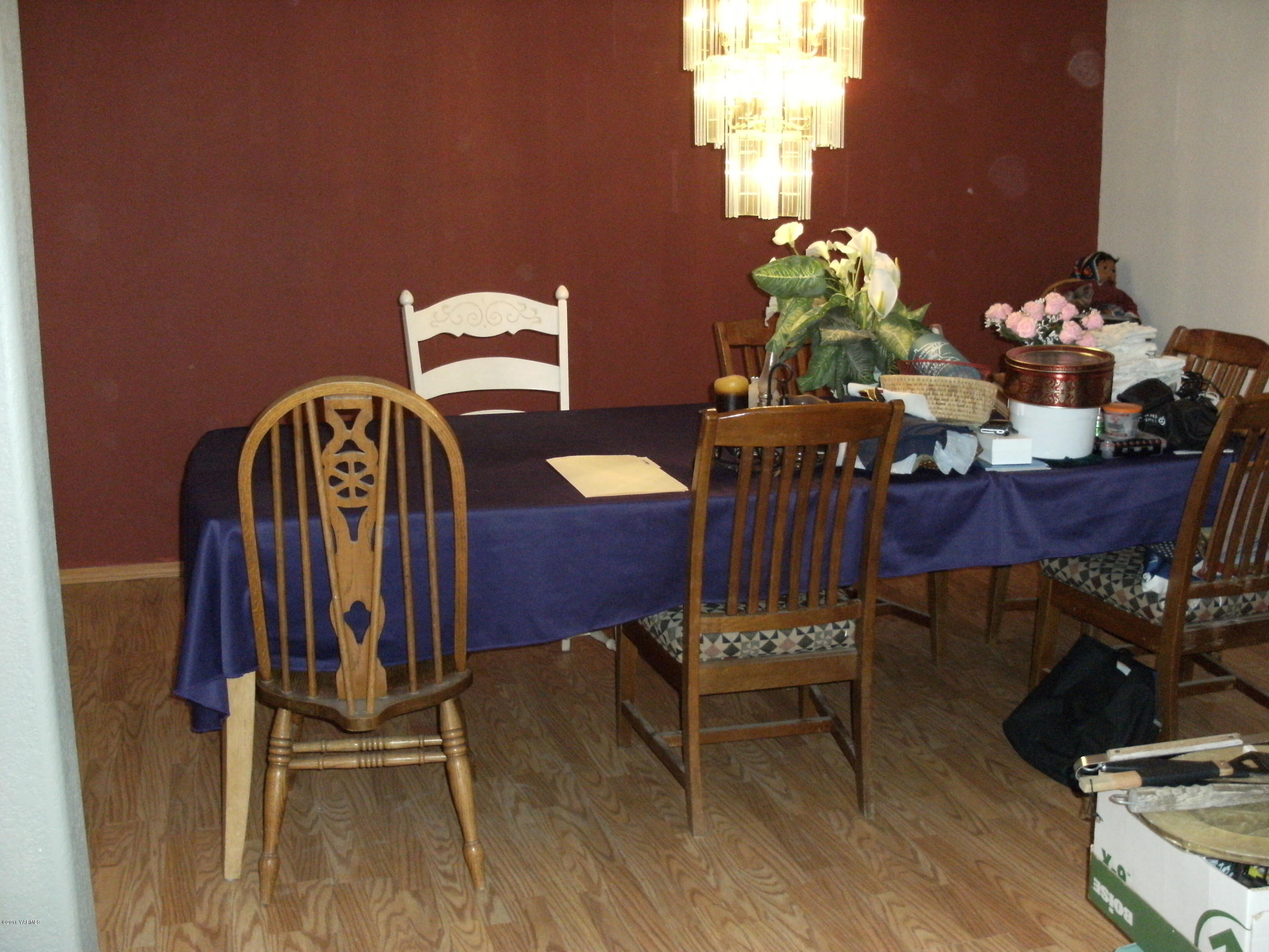 1009 Thornton Road Sunnyside, WA 98944 - Photo 3 of 18 a view of a dining room with furniture and wooden floor