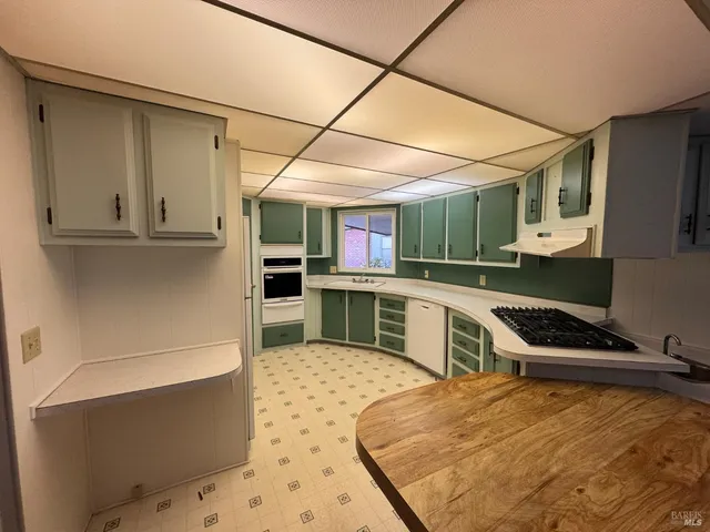 a kitchen with a stove a sink and a refrigerator