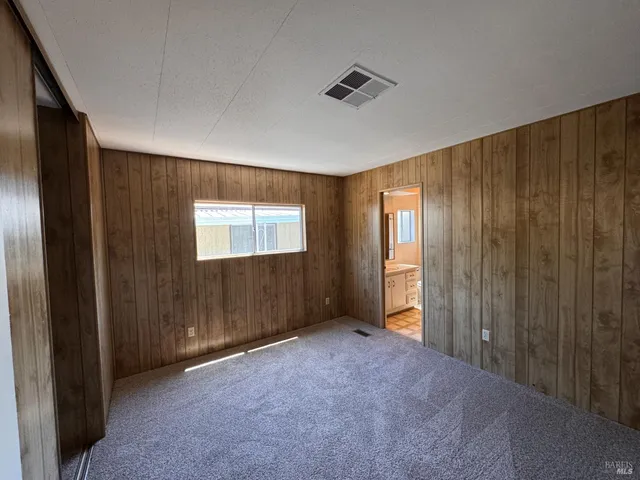 a view of hallway with furniture and a window