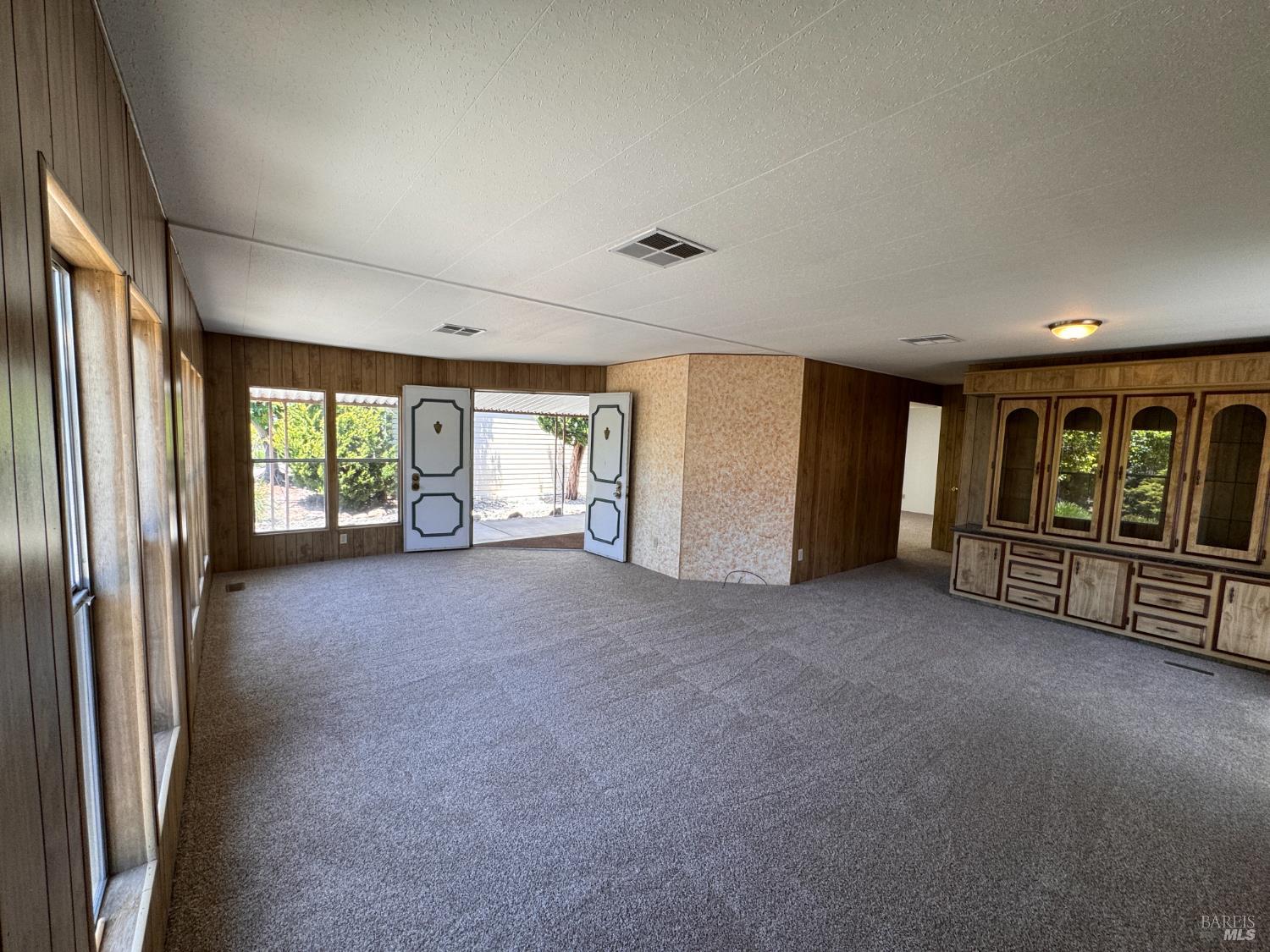 91 Greenrock Court Santa Rosa, CA 95409 - Photo 8 of 31 a view of an empty room with windows & cabinet