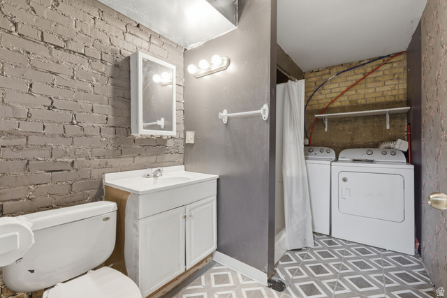 869 West Center Street Provo, UT 84601 - Photo 30 of 32 Full bathroom featuring brick wall, a shower with shower curtain, vanity, independent washer and dryer, and light flooring