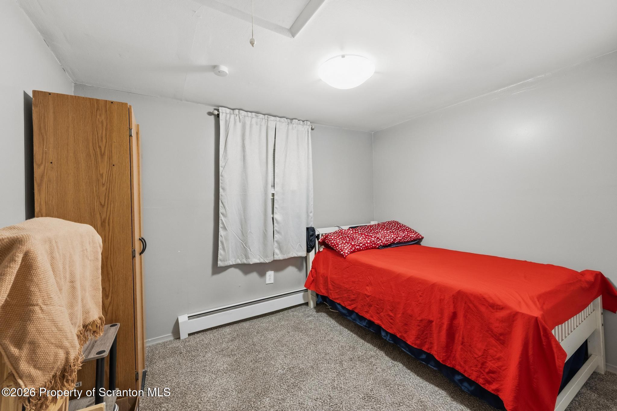 138 Swetland Street Duryea, PA 18642 - Photo 12 of 34 a bedroom with a bed and a window