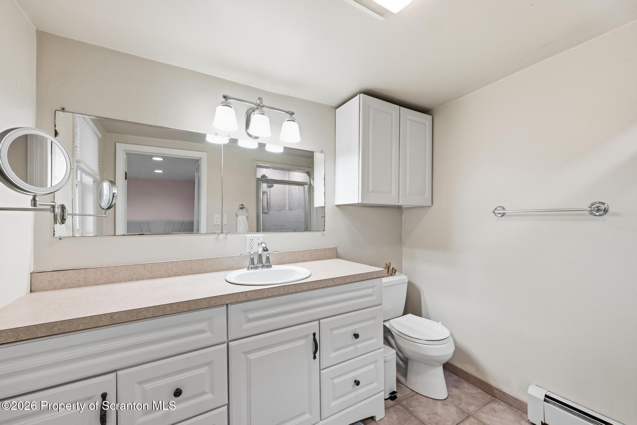 138 Swetland Street Duryea, PA 18642 - Photo 17 of 34 a bathroom with a toilet a sink and mirror