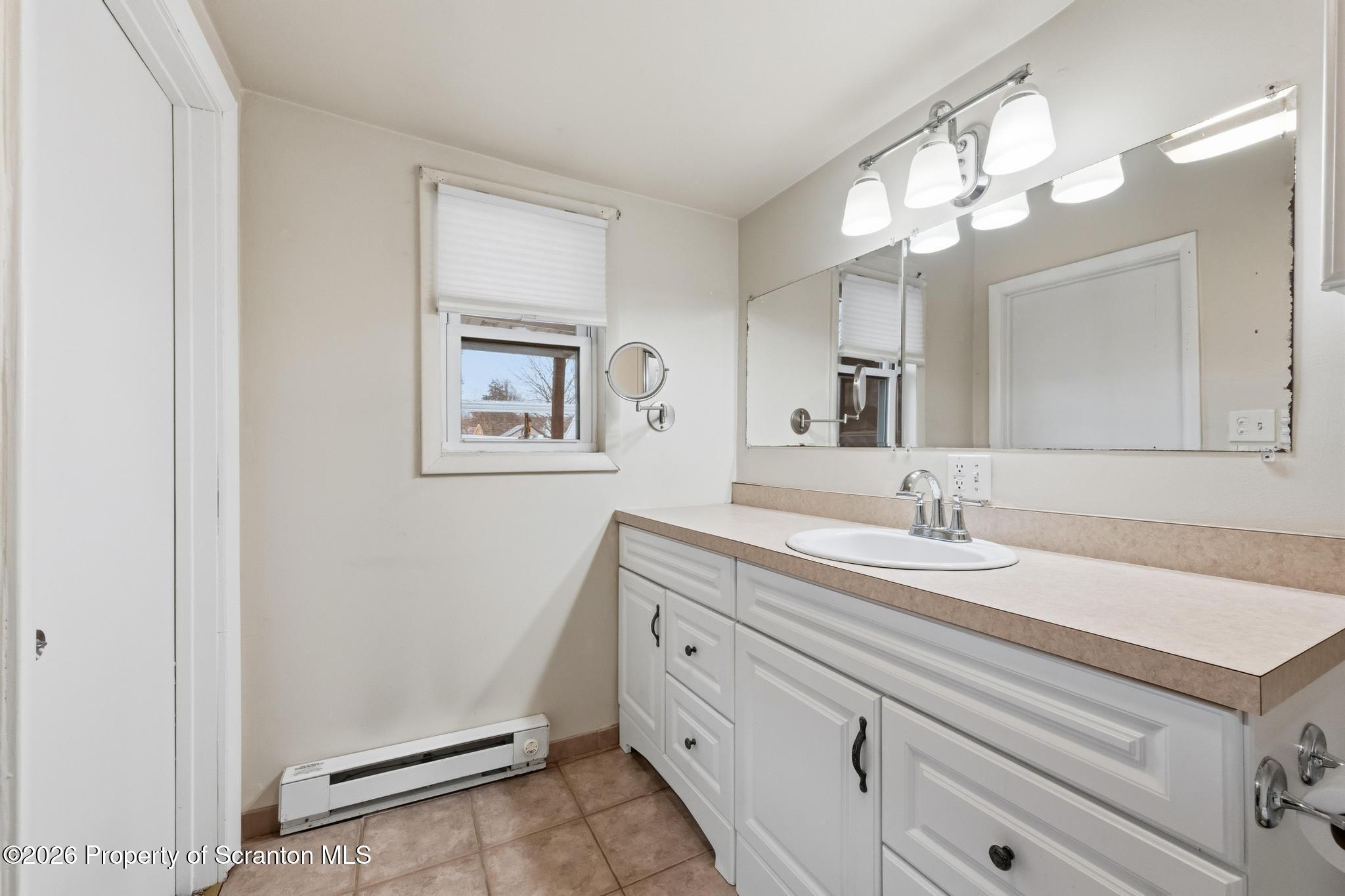 138 Swetland Street Duryea, PA 18642 - Photo 18 of 34 a bathroom with a granite countertop sink and a mirror