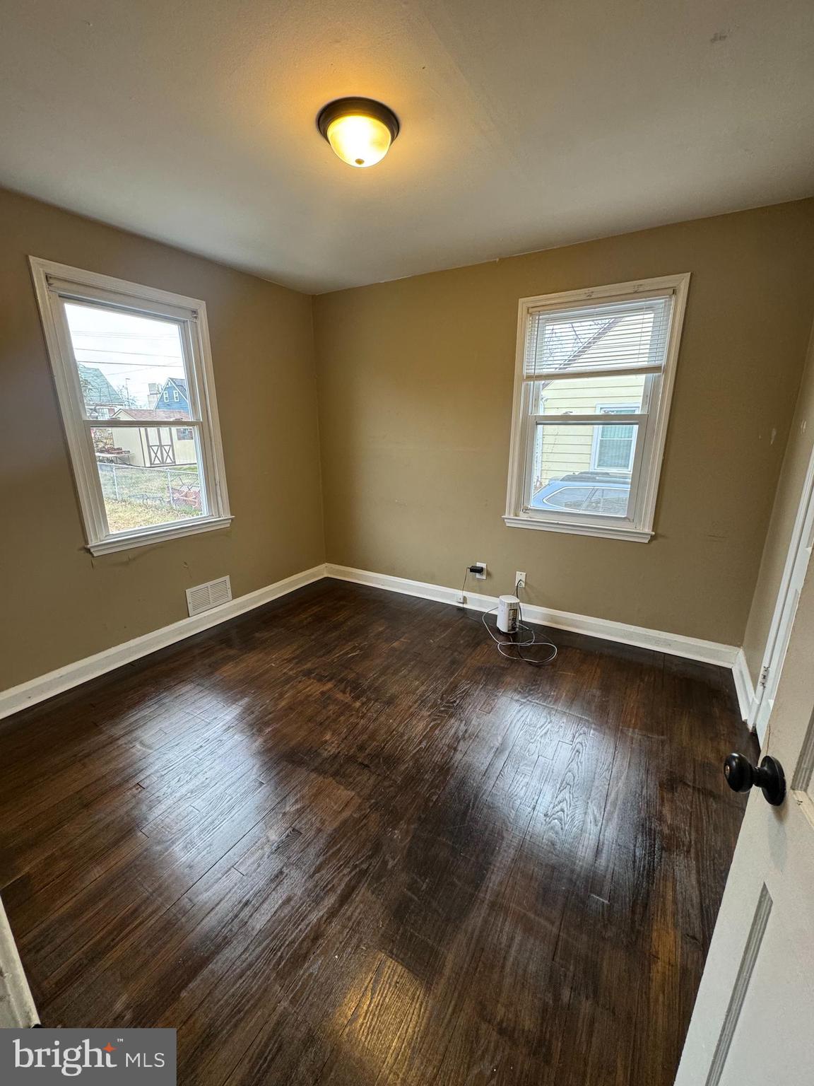 7408 Digby Road Gwynn Oak, MD 21207 - Photo 2 of 7 a view of a livingroom with wooden floor and a window