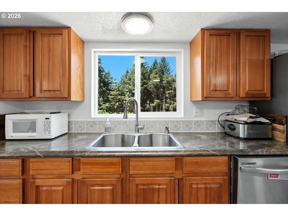 34155 Southeast Moss Hill Road Estacada, OR 97023 - Photo 20 of 26 a kitchen with granite countertop a sink window and cabinets