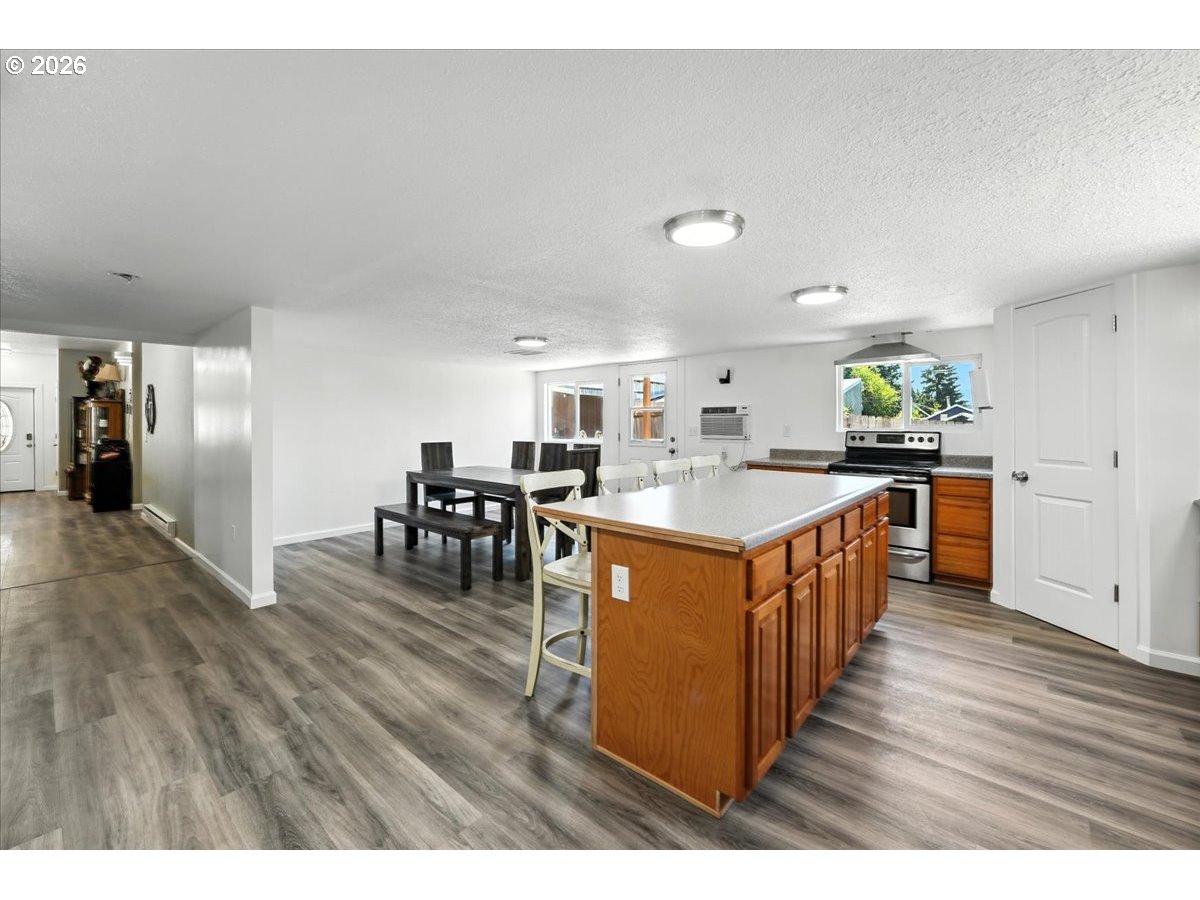34155 Southeast Moss Hill Road Estacada, OR 97023 - Photo 21 of 26 a open kitchen with stainless steel appliances granite countertop a table chairs and a refrigerator