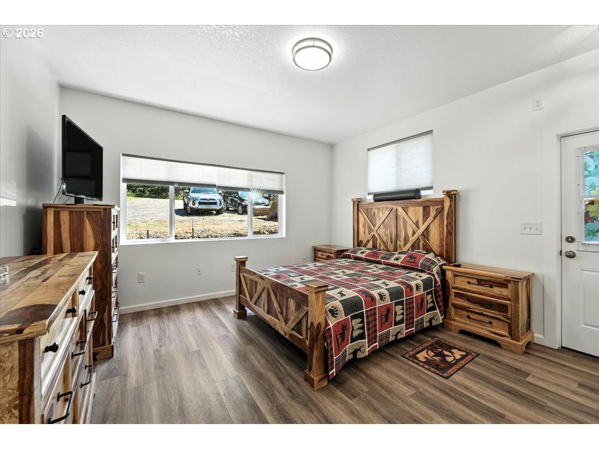 34155 Southeast Moss Hill Road Estacada, OR 97023 - Photo 7 of 26 a bedroom with a bed and a flat screen tv