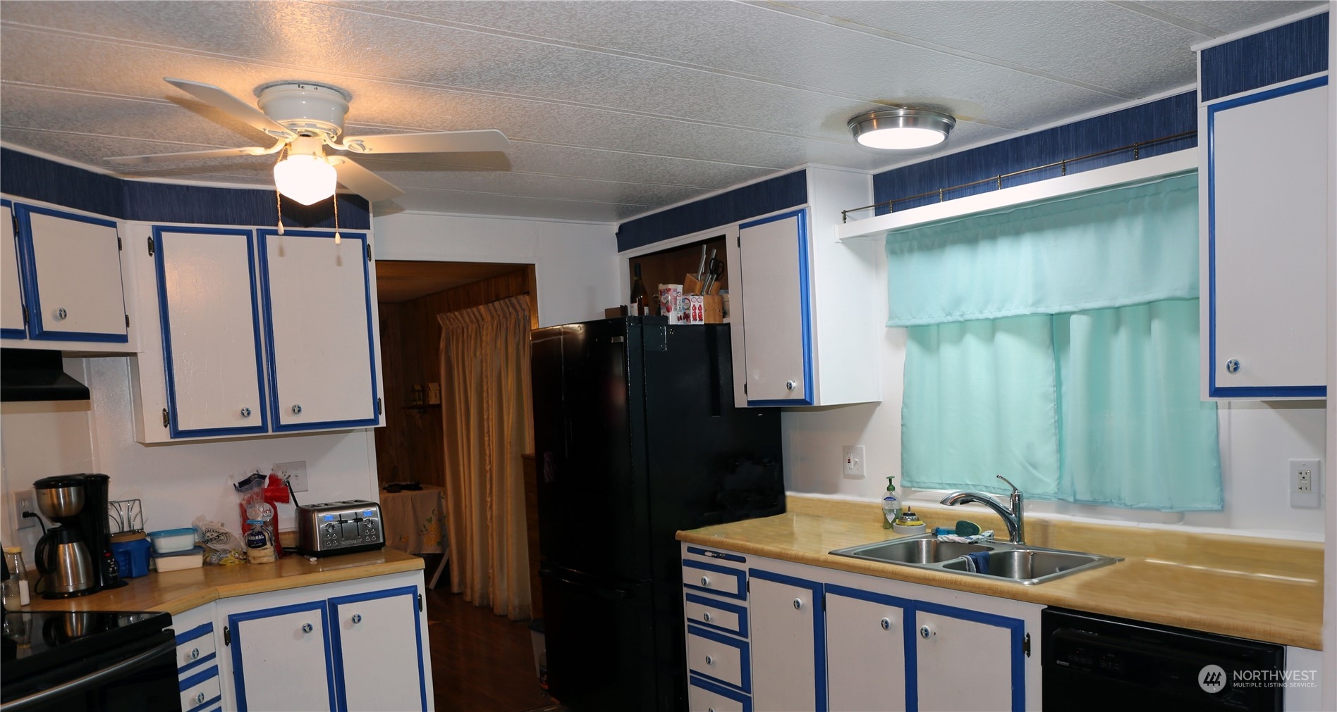 802 South Military Road Winlock, WA 98596 - Photo 4 of 14 a kitchen with a refrigerator and a sink