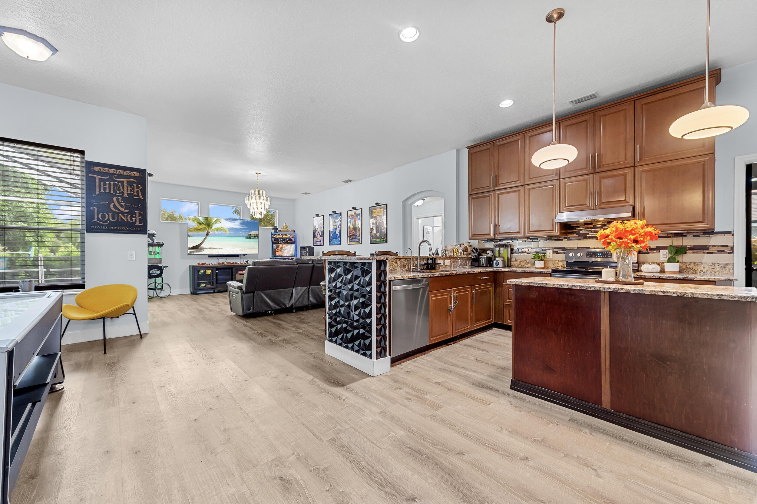 3183 Southwest Ann Arbor Road Port St. Lucie, FL 34953 - Photo 3 of 16 a living room with furniture kitchen and a wooden floor