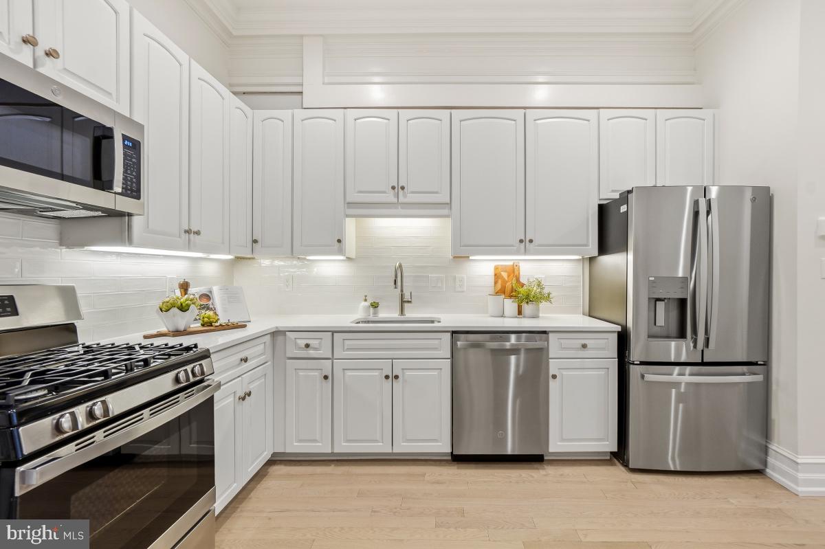 1706 16th Street Northwest, Unit 1 Washington, DC 20009 - Photo 14 of 55 a kitchen with appliances a sink and cabinets
