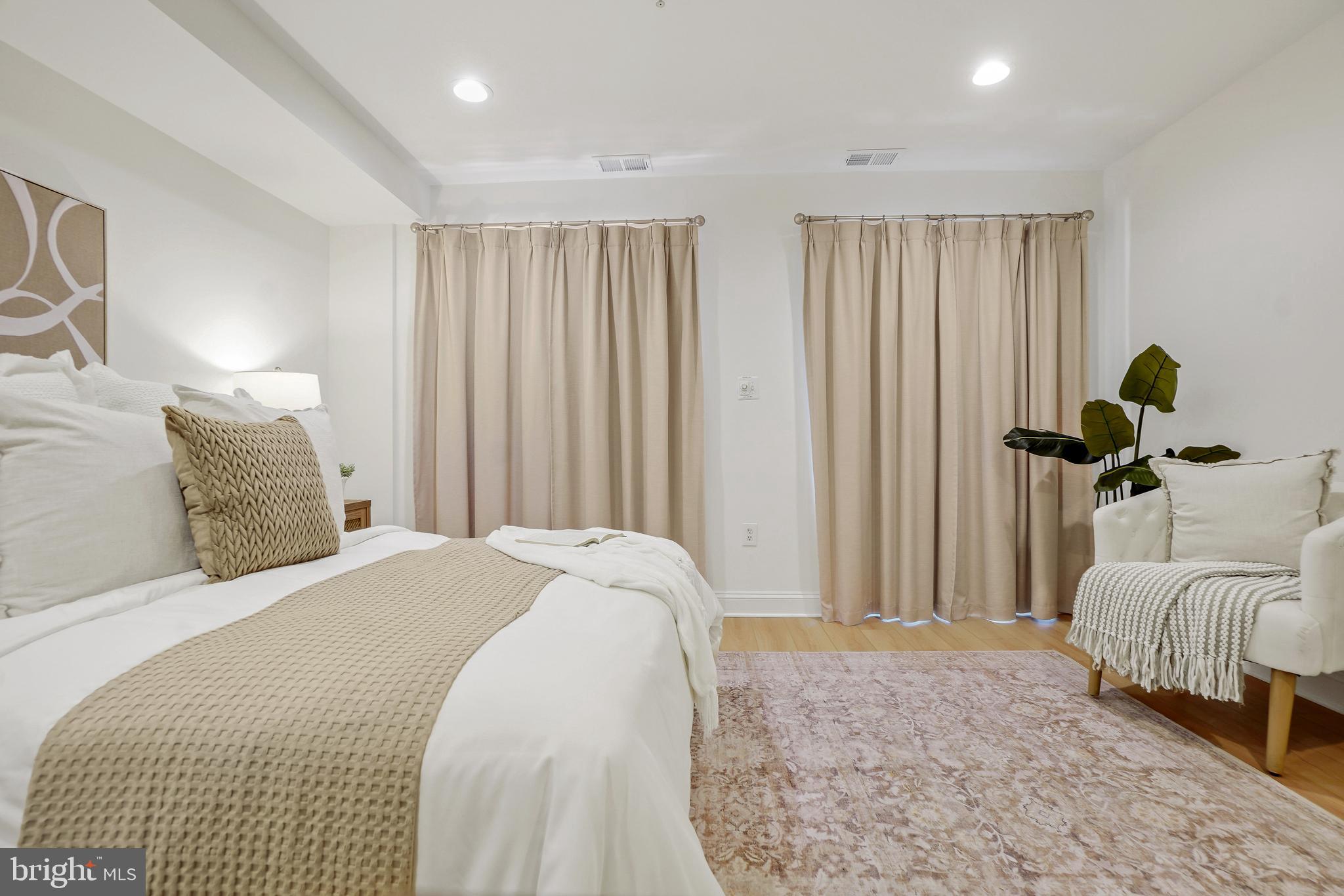 1706 16th Street Northwest, Unit 1 Washington, DC 20009 - Photo 26 of 55 a bedroom with a bed and a couch