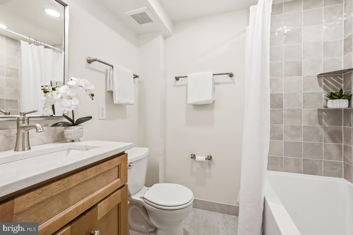 1706 16th Street Northwest, Unit 1 Washington, DC 20009 - Photo 30 of 55 a bathroom with a sink a toilet and a mirror