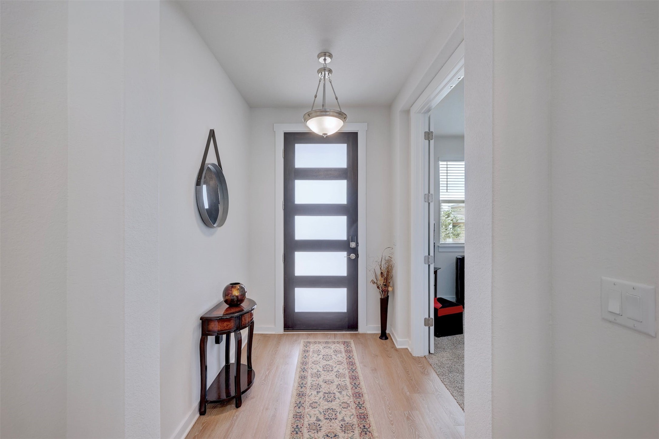 2041 Centerline Lane Georgetown, TX 78628 - Photo 5 of 31 a view of a hallway with windows and chandelier fan