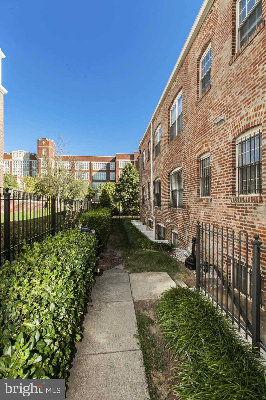 1 18th Street Southeast, Unit 301 Washington, DC 20003 - Photo 17 of 19 a view of a pathway with a house in the background