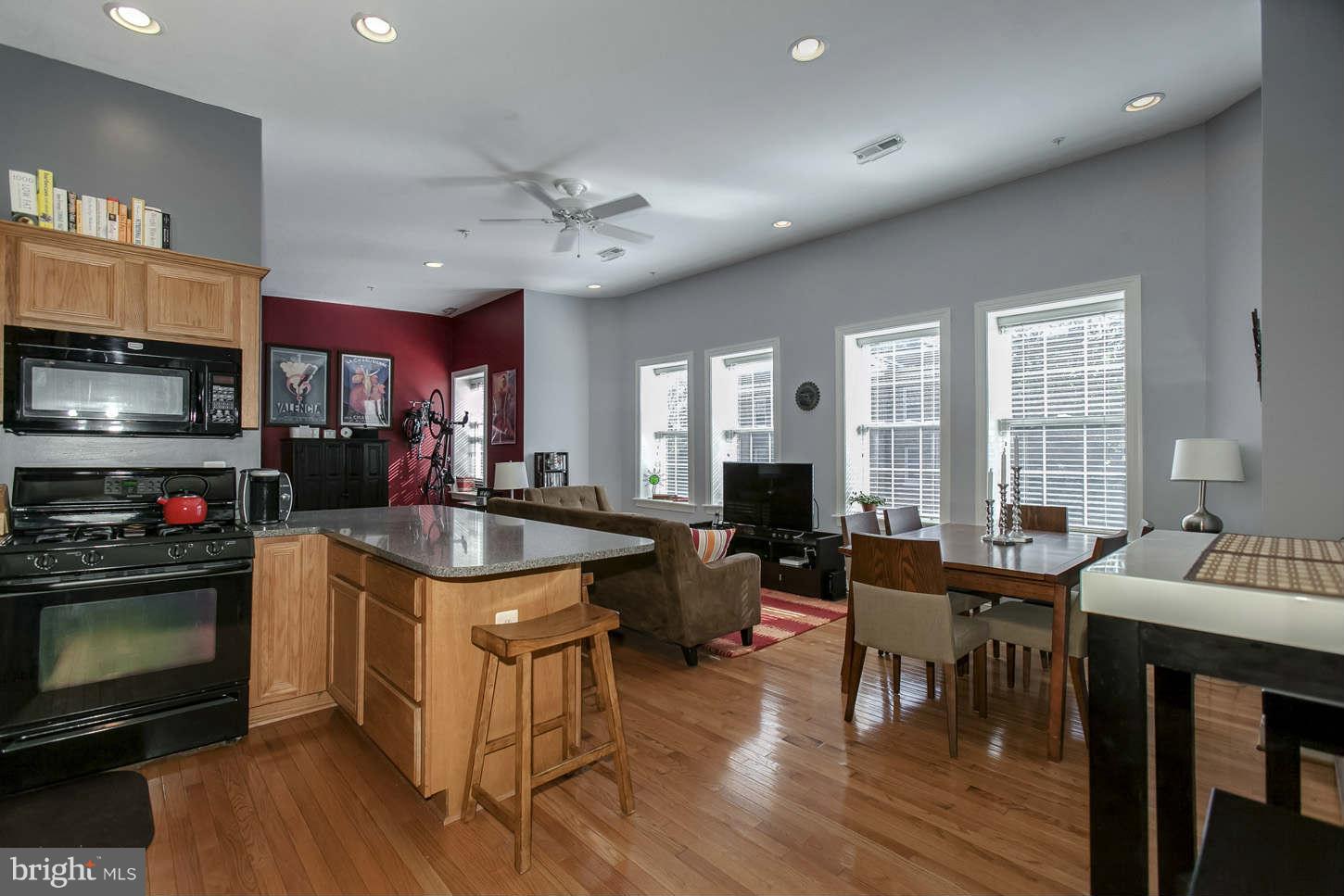 1 18th Street Southeast, Unit 301 Washington, DC 20003 - Photo 4 of 19 a view of a dining room with furniture window and wooden floor