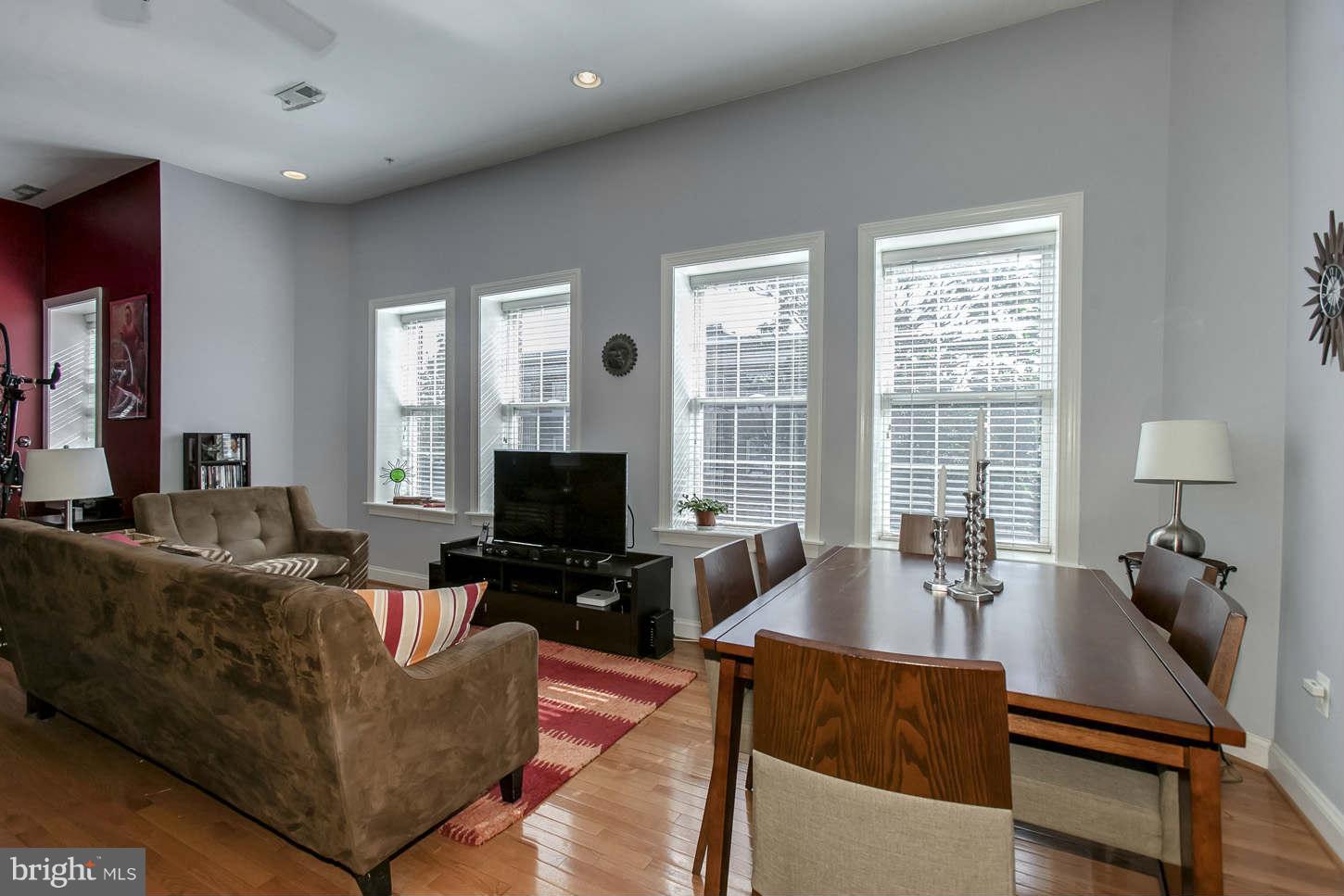 1 18th Street Southeast, Unit 301 Washington, DC 20003 - Photo 7 of 19 a living room with furniture and a flat screen tv