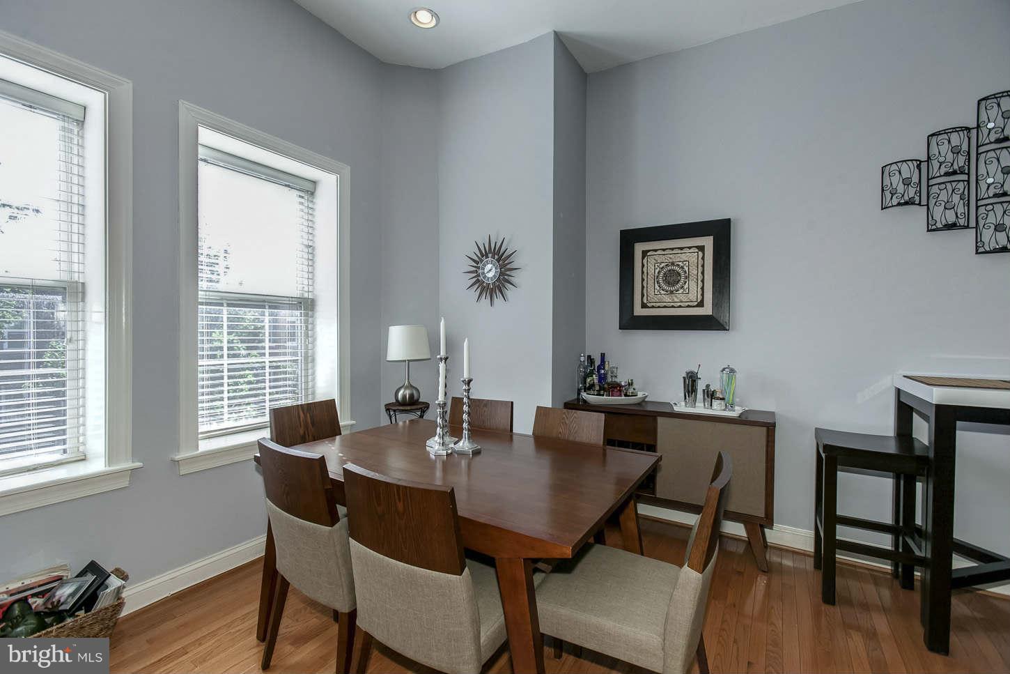 1 18th Street Southeast, Unit 301 Washington, DC 20003 - Photo 8 of 19 a view of a dining room with furniture window and wooden floor