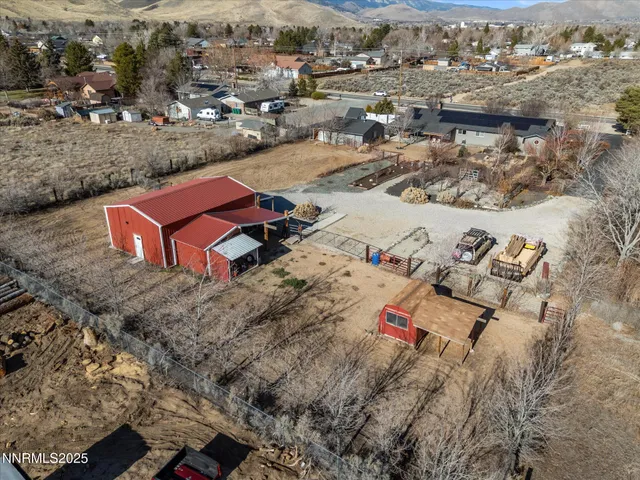 an aerial view of a house with a yard tennis court