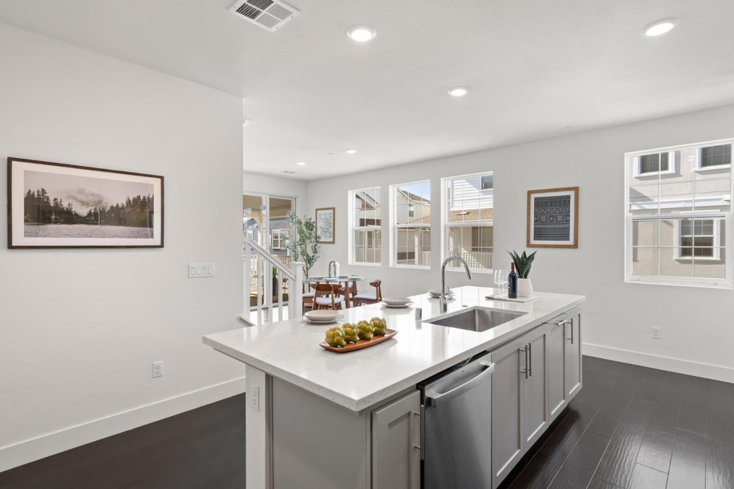9488 Seawind Way Newark, CA 94560 - Photo 11 of 33 a kitchen with a sink a cabinets and wooden floor