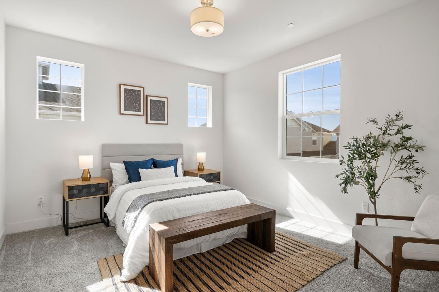 9488 Seawind Way Newark, CA 94560 - Photo 15 of 33 a bedroom with a large bed and a potted plant