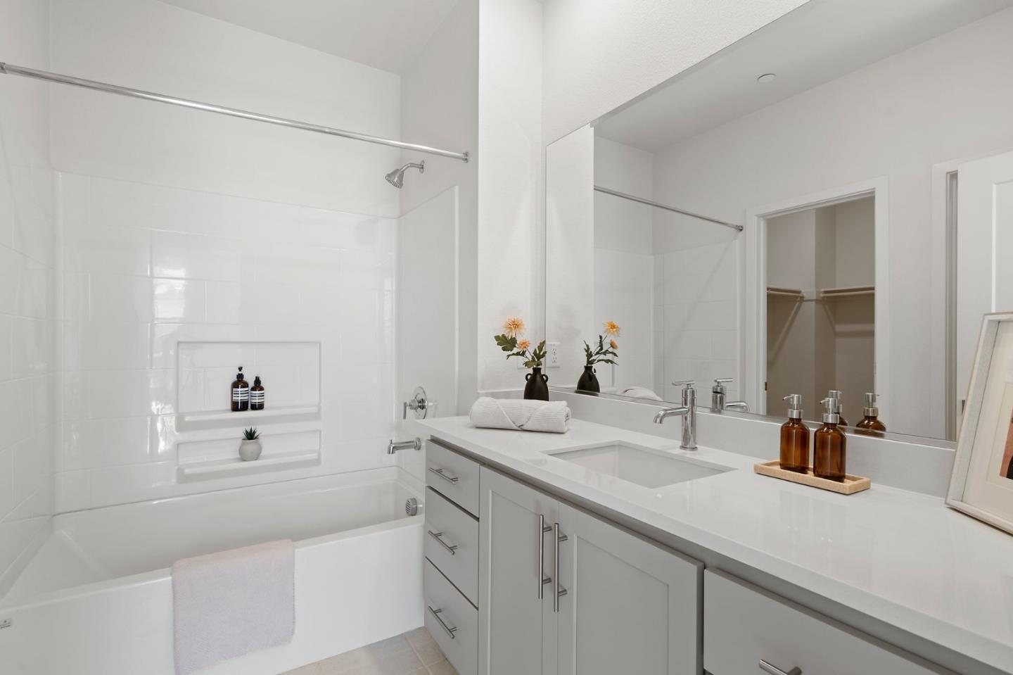 9488 Seawind Way Newark, CA 94560 - Photo 21 of 33 a bathroom with a shower sink vanity and mirror