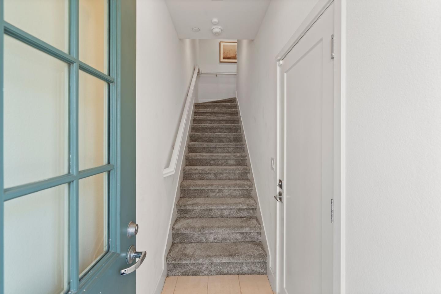 9488 Seawind Way Newark, CA 94560 - Photo 3 of 33 a view of a hallway with wooden floor and staircase