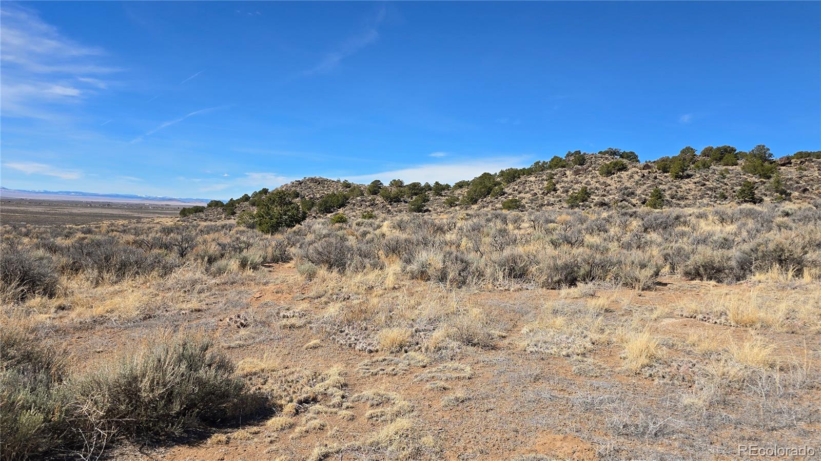 Lot 75 Old Stage Coach Road San Luis, CO 81152 - Photo 10 of 17 a view of a dry yard with mountains in the background