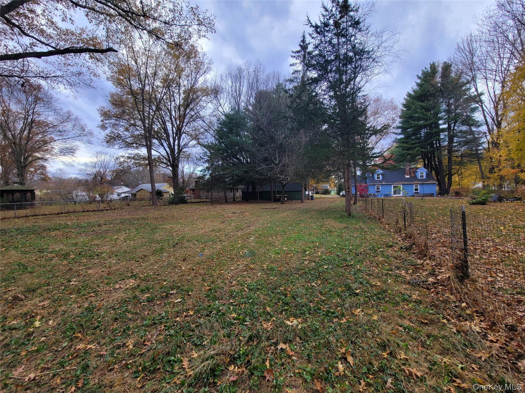 7 Smith Street Red Hook, NY 12571 - Photo 22 of 23 a view of a yard with a house in the background