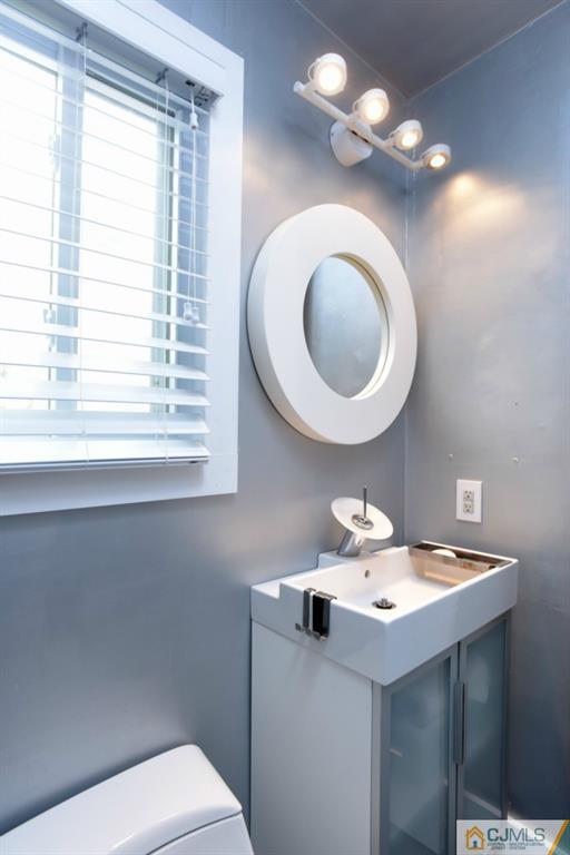 3 Cummings Road Monmouth Junction, NJ 08852 - Photo 22 of 23 a bathroom with a toilet a sink and a mirror