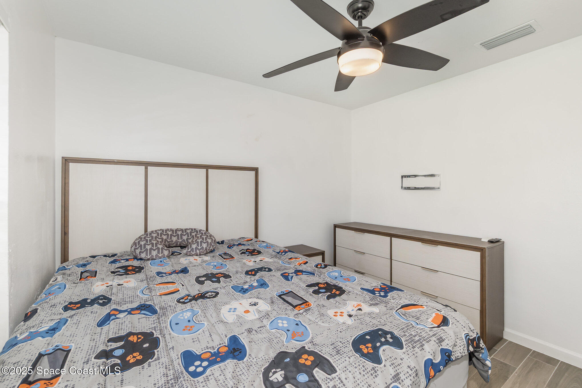 1534 Pine Street Orlando, FL 32824 - Photo 12 of 28 a bedroom with a bed and a dresser