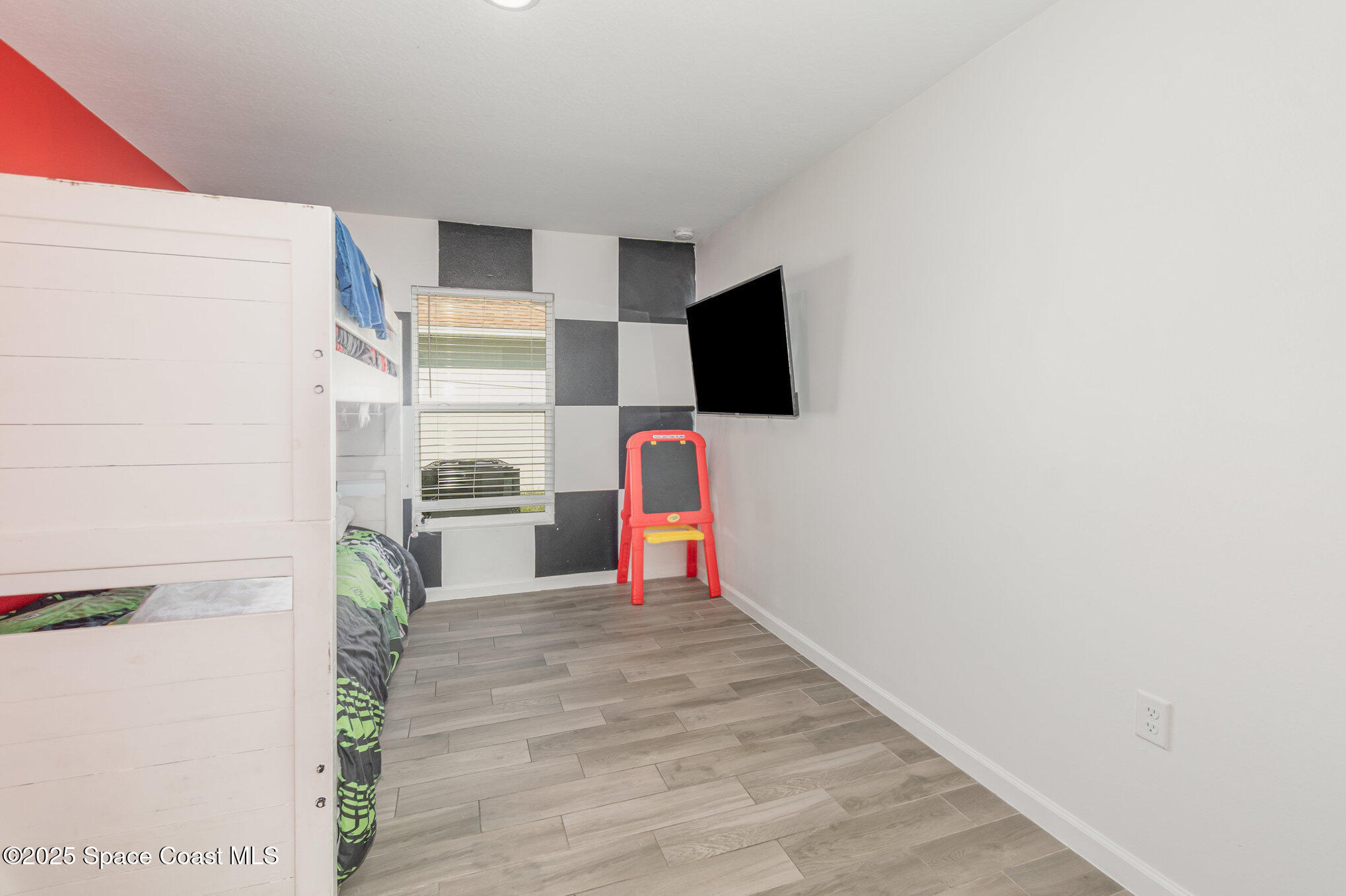 1534 Pine Street Orlando, FL 32824 - Photo 13 of 28 a bedroom with a bed and a flat screen tv