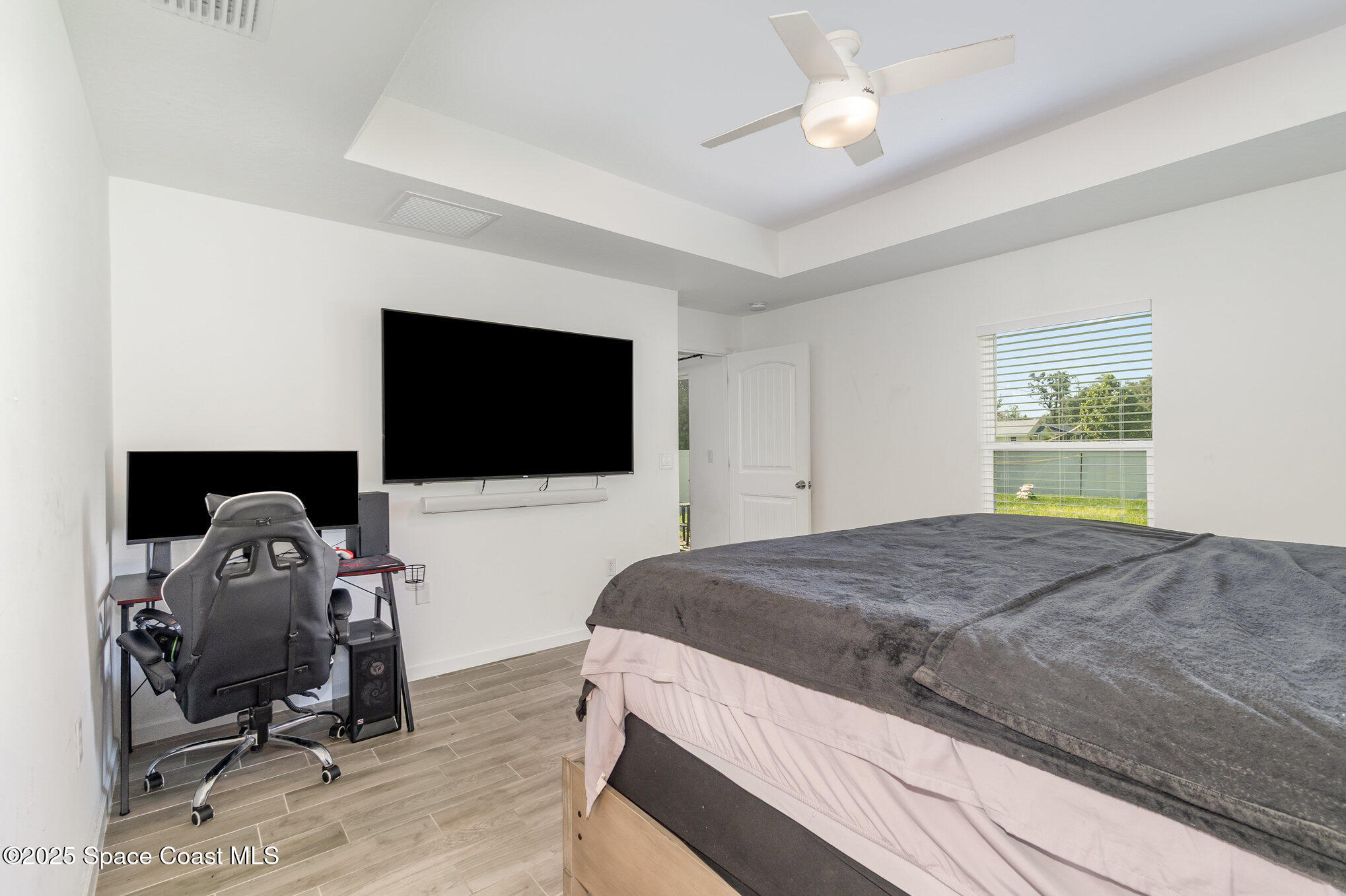 1534 Pine Street Orlando, FL 32824 - Photo 23 of 28 a bedroom with a bed and a flat screen tv