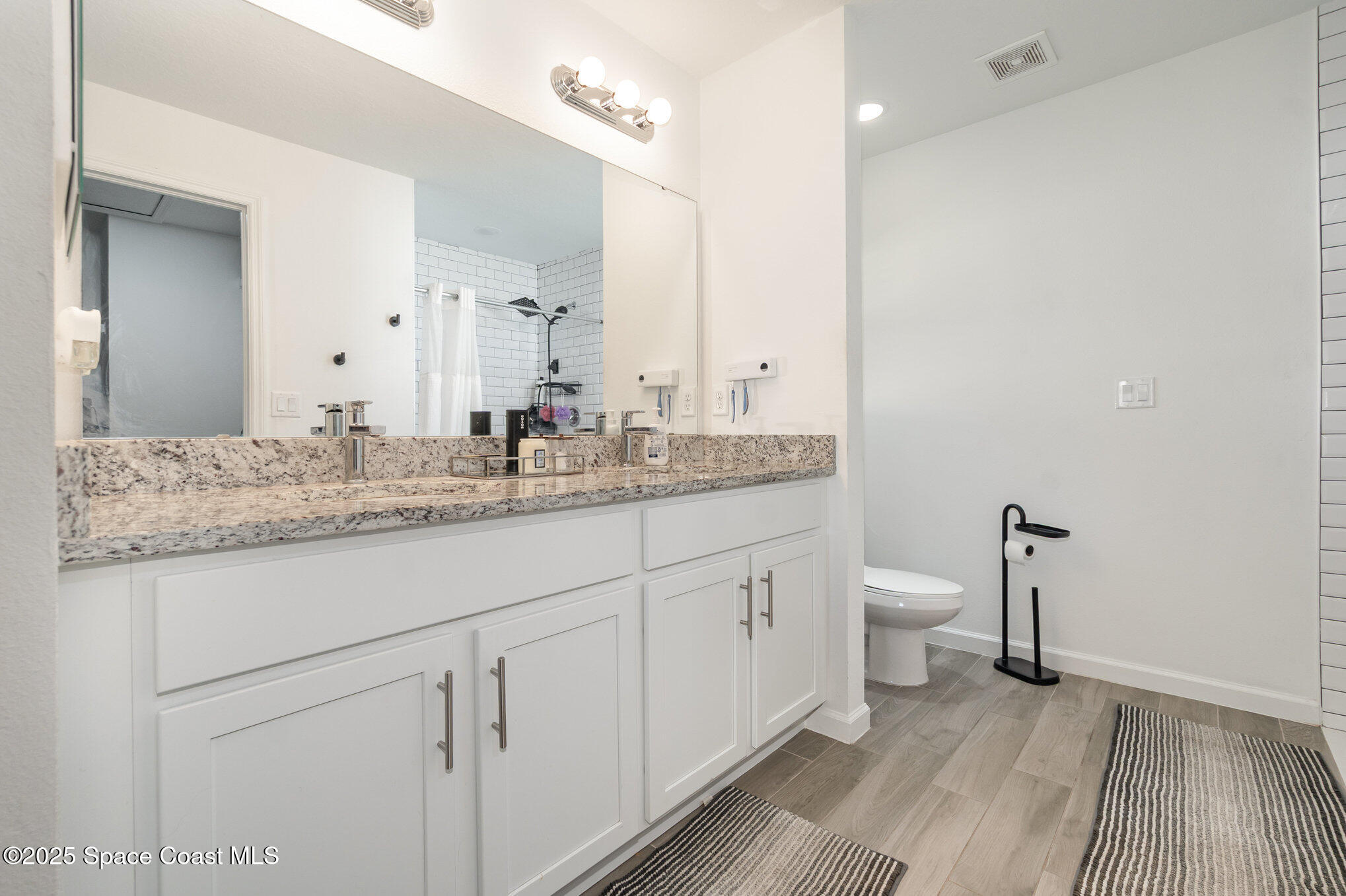 1534 Pine Street Orlando, FL 32824 - Photo 24 of 28 a bathroom with a granite countertop sink mirror and toilet