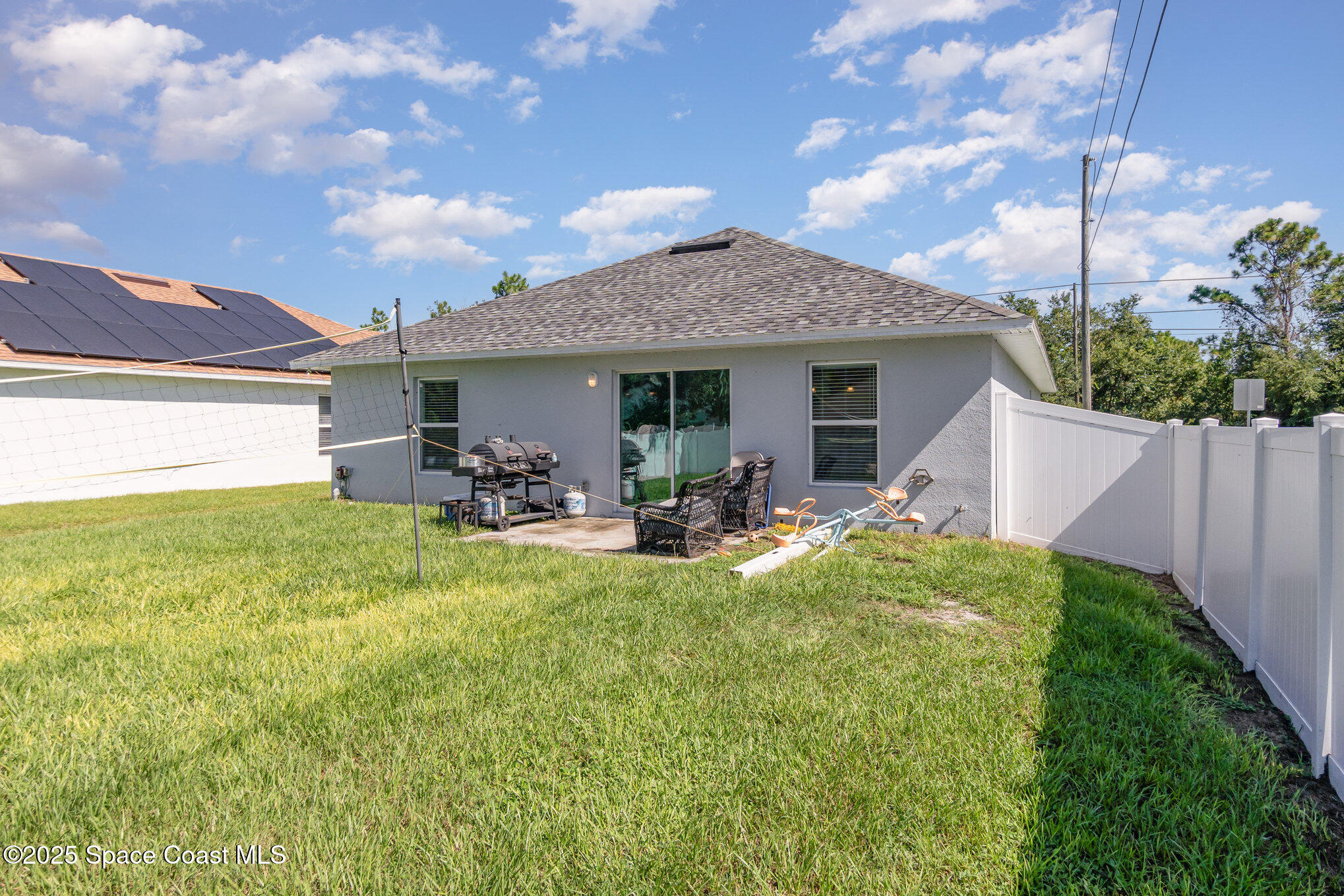 1534 Pine Street Orlando, FL 32824 - Photo 27 of 28 a view of a house with backyard sitting area and garden