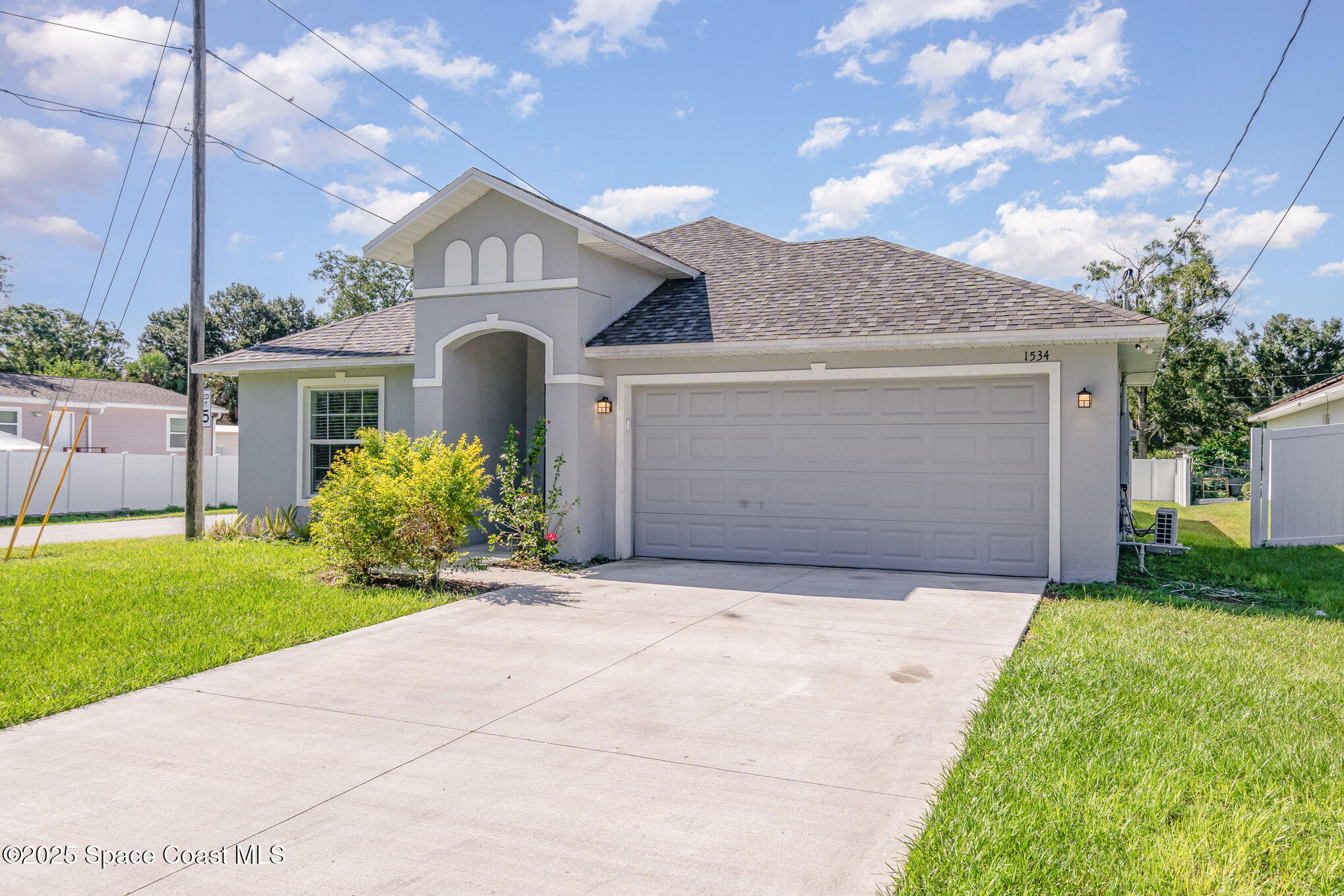 1534 Pine Street Orlando, FL 32824 - Photo 3 of 28 a front view of a house with a garden and plants
