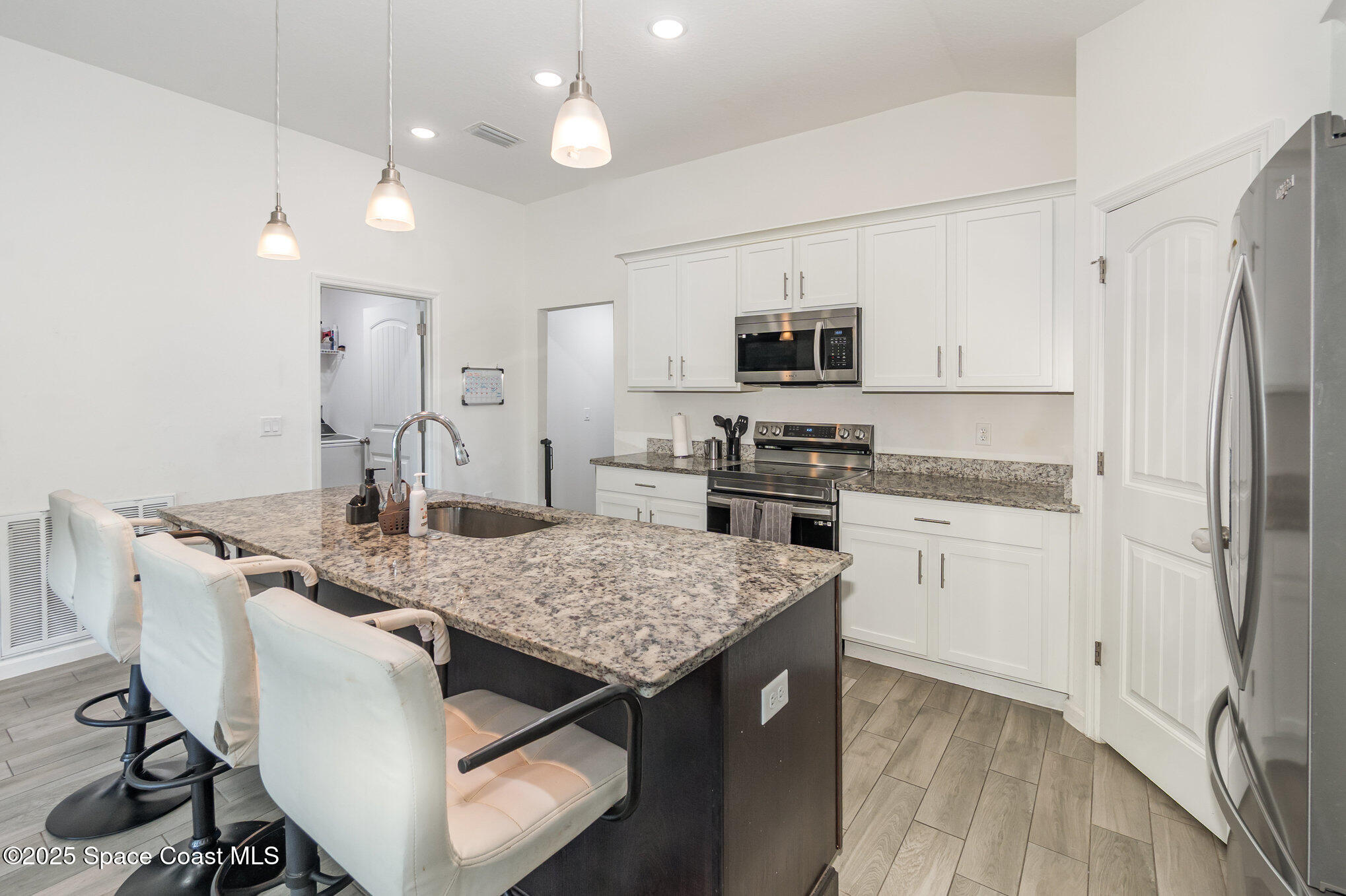 1534 Pine Street Orlando, FL 32824 - Photo 8 of 28 a kitchen with kitchen island a sink stove and refrigerator