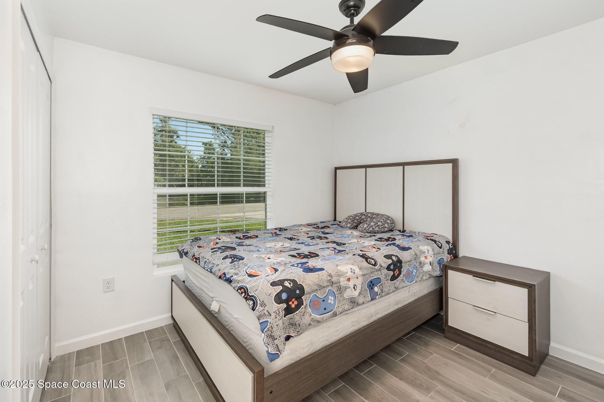 1534 Pine Street Orlando, FL 32824 - Photo 10 of 28 a bed sitting in a bedroom next to a window