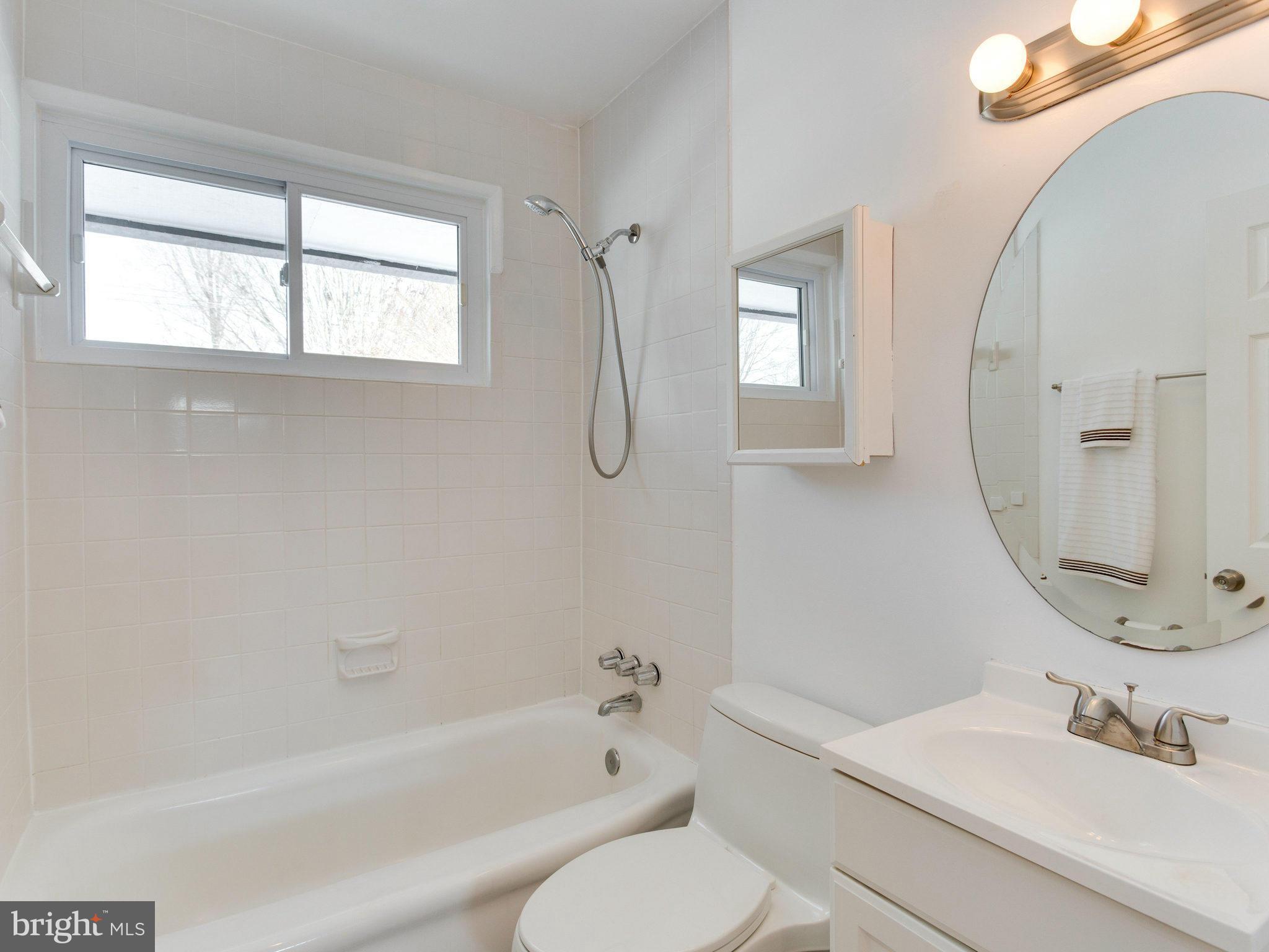 7315 Inzer Street Springfield, VA 22151 - Photo 18 of 23 a bathroom with a tub sink toilet and mirror