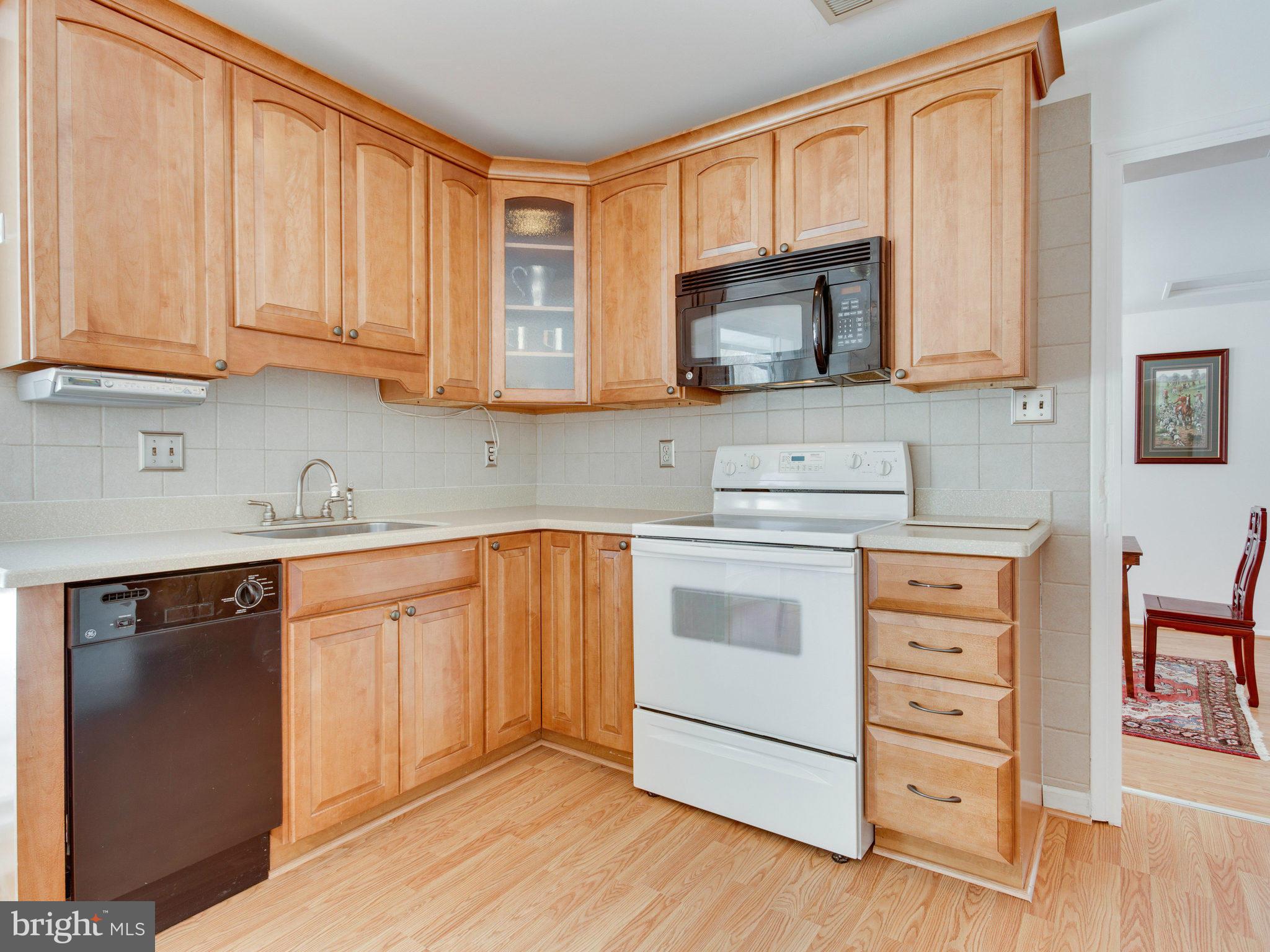 7315 Inzer Street Springfield, VA 22151 - Photo 5 of 23 a kitchen with stainless steel appliances granite countertop a sink stove and cabinets